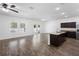 Open-concept living area with hardwood floors, natural light, and a kitchen island at 4924 Saint James St, Winter Haven, FL 33881