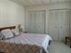 Comfortable bedroom featuring neutral walls, a cozy bed, and convenient built in closet for storage at 6059 Southern Oaks Se Dr, Winter Haven, FL 33884