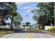 Community entrance features a guard house and lush landscaping at 6059 Southern Oaks Se Dr, Winter Haven, FL 33884