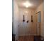 The entryway features wood-look wall paneling, flooring, and unique light fixtures for an inviting interior at 6059 Southern Oaks Se Dr, Winter Haven, FL 33884