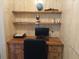 Practical home office space featuring a wooden desk, open shelving, and a comfortable chair at 6059 Southern Oaks Se Dr, Winter Haven, FL 33884