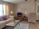 Inviting living room featuring neutral-toned furniture, including recliners, and a patterned rug at 6059 Southern Oaks Se Dr, Winter Haven, FL 33884