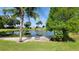 Scenic pond with water lilies and a bench to enjoy the natural views at 6059 Southern Oaks Se Dr, Winter Haven, FL 33884