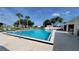 Outdoor community swimming pool surrounded by lounge chairs and landscaping at 6059 Southern Oaks Se Dr, Winter Haven, FL 33884