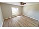 Bedroom with hardwood flooring, light gray walls, and natural lighting from the large windows at 618 Chester Dr, Lakeland, FL 33803