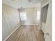 Bedroom with hardwood flooring, light gray walls, and two windows providing natural lighting at 618 Chester Dr, Lakeland, FL 33803