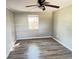 Bedroom featuring a ceiling fan, wood laminate floors, and natural light at 618 Chester Dr, Lakeland, FL 33803