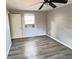 Bedroom featuring a ceiling fan, wood laminate floors, and natural light at 618 Chester Dr, Lakeland, FL 33803