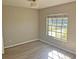 Cozy bedroom featuring laminate floors, a ceiling fan, and a window for natural light at 618 Chester Dr, Lakeland, FL 33803