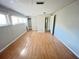 Bedroom with hardwood flooring, light gray walls, and natural lighting from the windows at 618 Chester Dr, Lakeland, FL 33803