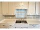 Kitchen featuring white cabinets, stainless steel sink, and laminate countertops at 618 Chester Dr, Lakeland, FL 33803