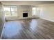 Spacious living room featuring wood-look flooring and a white-brick fireplace at 618 Chester Dr, Lakeland, FL 33803