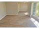 Bright living room featuring laminate floors and a large window for ample natural light at 618 Chester Dr, Lakeland, FL 33803