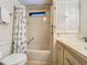 Bathroom featuring a shower/tub combination with a window, shuttered cabinet and seaside themed decor at 6336 Bayberry Blvd Ne, Winter Haven, FL 33881