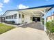 Attractive single-story home with a covered carport, verdant lawn, and quaint awning-covered windows at 6336 Bayberry Blvd Ne, Winter Haven, FL 33881