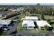 Aerial view of a neighborhood featuring well-maintained homes with white tile roofs and green lawns in a sunny environment at 720 Fonda Ct # 54, Lakeland, FL 33803
