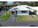 Beautiful aerial view featuring white-roofed homes, with well-kept lawns and mature trees in a peaceful residential neighborhood at 720 Fonda Ct # 54, Lakeland, FL 33803