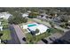 An overhead view of a community clubhouse with a pool, palm trees, and ample parking at 720 Fonda Ct # 54, Lakeland, FL 33803