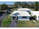 Birds eye view shows beautiful homes with white roofs, well-manicured landscaping, and mature trees in a quiet neighborhood at 720 Fonda Ct # 54, Lakeland, FL 33803