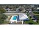 Beautiful aerial view of a community pool nestled amidst residential homes, blending leisure with neighborhood living at 720 Fonda Ct # 54, Lakeland, FL 33803