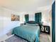 Comfortable bedroom boasts a plush bed, beach-themed artwork, and matching bedside tables for a restful ambiance at 720 Fonda Ct # 54, Lakeland, FL 33803