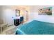 Bright bedroom features a modern desk, chair, and beach-themed artwork, providing a serene retreat at 720 Fonda Ct # 54, Lakeland, FL 33803