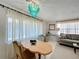 Bright dining area with a wooden table, sheer curtains, and comfortable seating at 720 Fonda Ct # 54, Lakeland, FL 33803