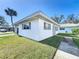 Well-maintained, single-story home with a white exterior, gray shutters, a concrete walkway, and a lush green lawn at 720 Fonda Ct # 54, Lakeland, FL 33803