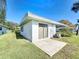 Well-maintained home exterior with a concrete patio, lush lawn, and tidy landscaping in a serene setting at 720 Fonda Ct # 54, Lakeland, FL 33803