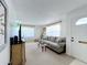 Bright living room with a cozy sofa, accent table, white door, and neutral rug at 720 Fonda Ct # 54, Lakeland, FL 33803