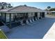 A community clubhouse featuring lounge chairs and table near the beautiful and well-maintained outdoor pool at 720 Fonda Ct # 54, Lakeland, FL 33803