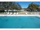 Relaxing view of a stunning community pool with lounge chairs and a glimpse of the surrounding neighborhood at 720 Fonda Ct # 54, Lakeland, FL 33803