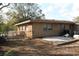 View of the home's backyard with a concrete patio and partial chain link fence at 807 S 1St St, Lake Wales, FL 33853