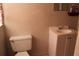 Functional bathroom featuring white fixtures, including toilet and sink, and neutral wall color at 807 S 1St St, Lake Wales, FL 33853