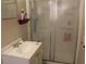 Functional bathroom featuring white fixtures, a shower with glass door and neutral wall color at 807 S 1St St, Lake Wales, FL 33853