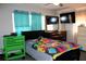 Bright bedroom featuring colorful bedding, neutral walls, and a ceiling fan with ample natural light at 807 S 1St St, Lake Wales, FL 33853