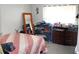 Bright bedroom featuring striped bedding, dark wood furniture, neutral walls, and a mirror at 807 S 1St St, Lake Wales, FL 33853