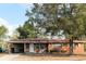 Charming single-story brick home with a covered carport and mature landscaping in the front yard at 807 S 1St St, Lake Wales, FL 33853