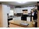 This L-shaped kitchen with white cabinets, a breakfast bar and modern appliances offers efficient meal preparation space at 807 S 1St St, Lake Wales, FL 33853