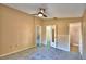 Bedroom featuring blue tiled floors, two doors, and a ceiling fan at 851 Hunt Cir, Lake Wales, FL 33853