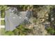 Aerial view of house with mature trees, deck, and roof at 907 Vistabula St, Lakeland, FL 33801