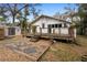 Spacious wood back deck leads to a fenced backyard featuring a storage shed and mature landscaping at 907 Vistabula St, Lakeland, FL 33801