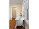 Bathroom featuring a white clawfoot tub, hardwood floors, and a bright window at 907 Vistabula St, Lakeland, FL 33801