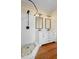 Bathroom with dual vanity, step in shower, and stylish finishes, featuring beautiful hardwood floors at 907 Vistabula St, Lakeland, FL 33801