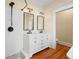 Bathroom with a walk-in shower, dual vanity, and hardwood floors; bright and stylish at 907 Vistabula St, Lakeland, FL 33801