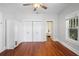 Bedroom featuring hardwood floors, closet, and view of a bathroom with a clawfoot tub at 907 Vistabula St, Lakeland, FL 33801