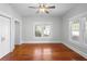 Bright bedroom with hardwood floors, ceiling fan, and natural light from large windows at 907 Vistabula St, Lakeland, FL 33801