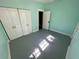 Tranquil bedroom featuring blue walls, painted wood floors, and ample closet space at 907 Vistabula St, Lakeland, FL 33801