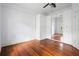 Spacious bedroom with polished hardwood floors and built-in wardrobe with mirrors at 907 Vistabula St, Lakeland, FL 33801