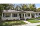Charming single story home with a covered front porch, landscaped front yard, and mature trees at 907 Vistabula St, Lakeland, FL 33801